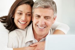 couple trying to understand bids at laptop